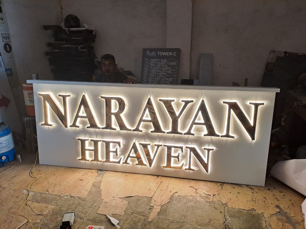 Backlit stainless-steel letters glowing with warm halo light
